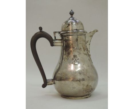 A silver coffee pot of plain baluster form having fruit wood handle, dome lid with finial and circular foot,  London 1904, ap