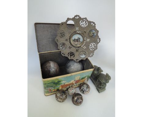 A vintage tin containing Scottish agate carpet bowls, a Victorian brass tazza having pictorial chapel decoration and a jadeit