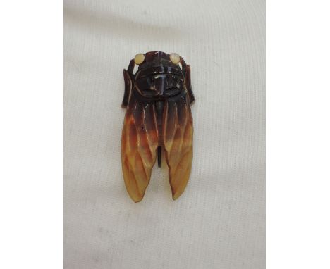 An Art Nouveau style Cicada horn brooch having mother of pearl set eyes, signed Flamand, Paris 