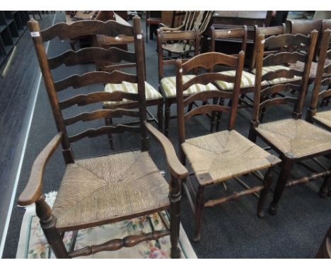 Six (4+2) elm vernacular harlequin chairs having ladder backs and rush seats and a similar chair