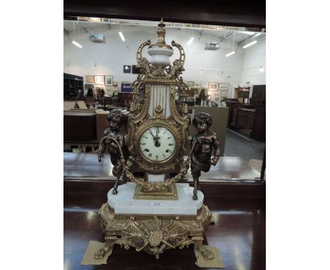 A late 20th century mantel clock in the Italian style having brass and white marble mount with cloven hoof cherub decoration