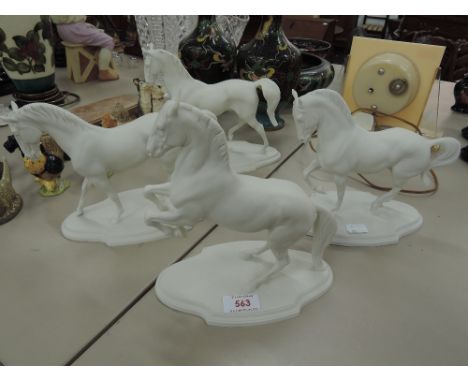 Four Levade ceramic figures modelled as white horses