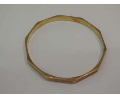A 9ct gold hollow bangle having engine turned decoration,  approx 14.7g