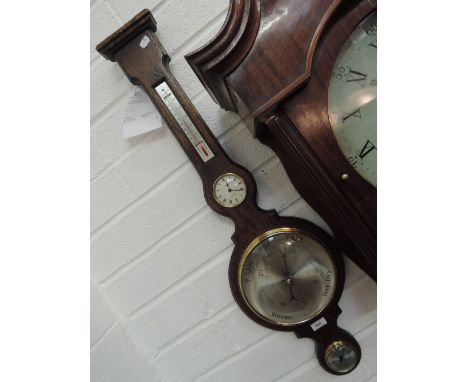 A modern oak cased aneroid banjo barometer in the Victorian style having thermometer and clock inset by Laveton, with receipt