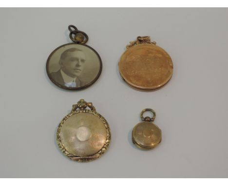 Three yellow metal lockets including a miniature yellow metal double sided mourning locket, a plain circular locket with insc