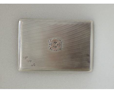 A silver cigarette case of slide action having engine turned decoration bearing London Scottish Regiment insignia and initial