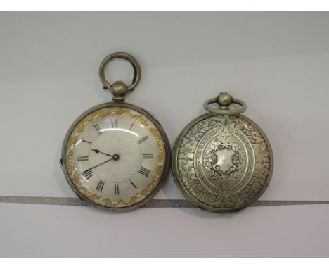 A ladies key wound white metal pocket watch stamped fine silver having a Roman numeral dial to decorative face, and another s