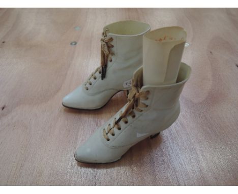 A pair of early 20th century German ceramic trinkets modelled as ladies boots