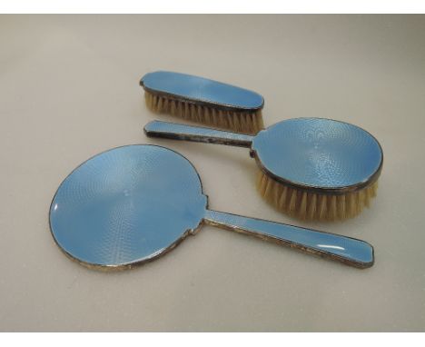 A three piece silver dressing table set having pale blue enamel guilloche decoration, Birmingham 1921, W G Sothers Ltd 