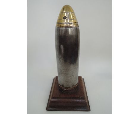 A trench art brass and chromed mortar shell case having removeable scale top and oak plinth