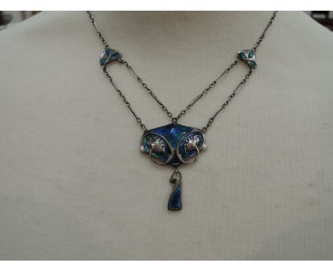 A white metal Art Nouveau pendant by Murrle Bennett & Co stamped 950, having floral decoration on blue and green enamelled gr