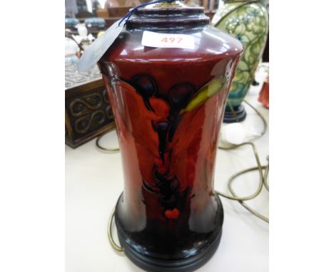 A Moorcroft table lamp in leaves and fruit pattern on flambe ground