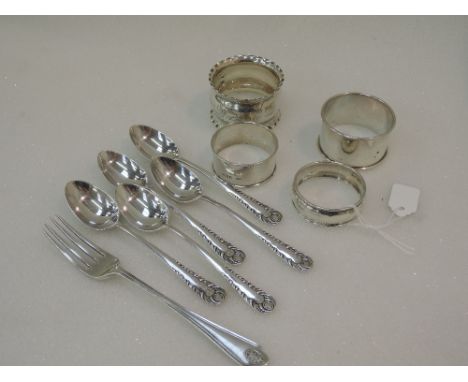Four HM silver napkin rings of various designs, a part set of HM silver teaspoons and a child's HM silver fork