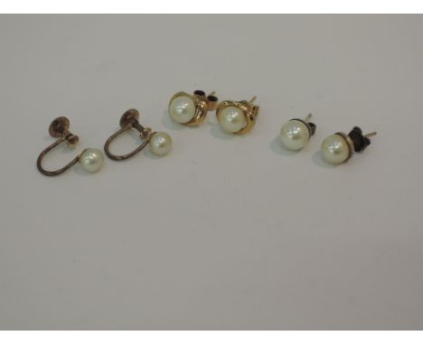 Three pairs of silver and yellow metal cultured pearl earrings including screw back, and stud