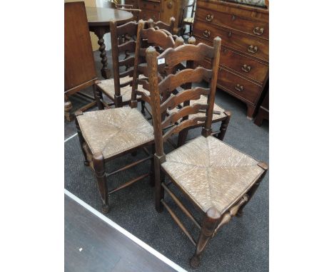 A set of four 19th century elm vernacular chairs having ladder backs, rush seats and turned legs