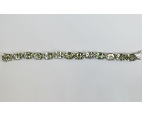 Green Amethyst Tennis Bracelet, 70cts of oval cut green amethyst set in platinum vermeil and silver, each amethyst being over