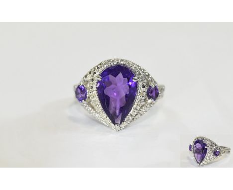 Pear Cut Amethyst Ring, a pear cut purple amethyst of 3.75cts,  flanked by two further amethysts totalling .5ct, set in silve