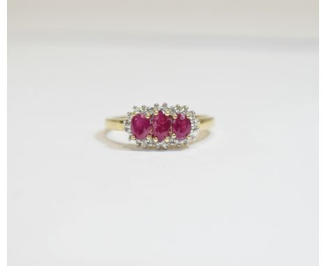 9 ct Diamond and Ruby Cluster Ring. Pretty, raised central setting with 3 oval rubies set amongst small diamonds.