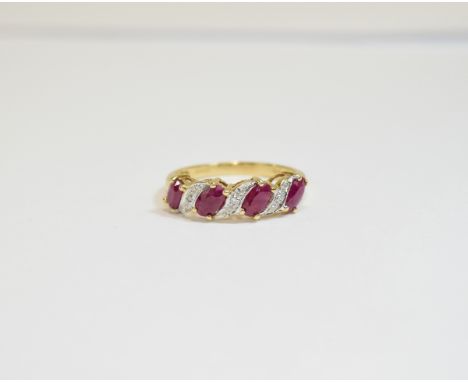 9ct Gold Diamond and Ruby Cluster Ring. Features 4 oval rubies between diamond chip inserts in raised setting.