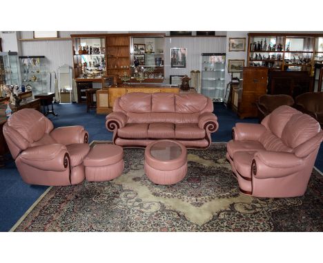 Three Piece Suite With matching coffee table and footstool dusky rose  leather with dark wood scroll detail to arms. Features