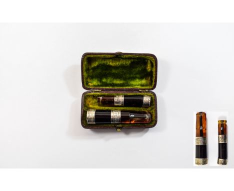 Antique Silver Set Cigarette Holder. Amber coloured resin with silver engraved banding, housed in original brown leather case