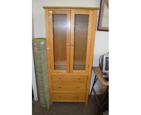 Modern light oak display cabinet with three drawer base