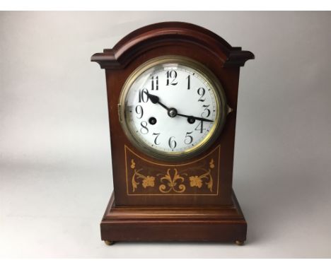 EDWARDIAN INLAID MAHOGANY MANTEL CLOCK, the white enamel dial with numbers in black, on brass ball feet