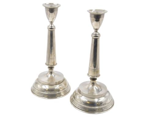 Pair of late 19th/early 20th century Austro-Hungarian 800 standard silver candlesticks, with tapering stems upon a domed base