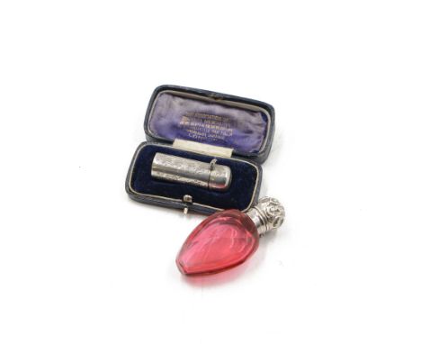 Victorian silver mounted ruby glass scent bottle, the glass body of faceted ovoid form, the silver cover embossed with foliat