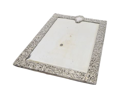 Late Victorian silver mounted dressing table mirror, of rectangular form, embossed throughout with C scrolls and foliage, wit