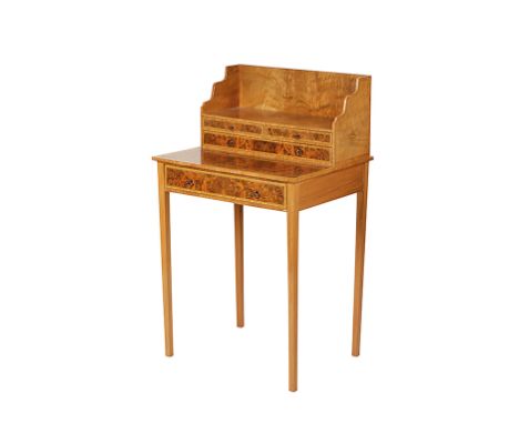 A SHERATON STYLE BURR WALNUT BONHEUR DU JOUR, the raised superstructure with an open shelf over three drawers, and the base w