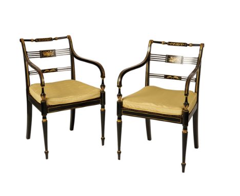 PAIR OF REGENCY EBONISED AND GILT ELBOW CHAIRS, each with a turned cresting rail centred by a panel decorated with acorns and