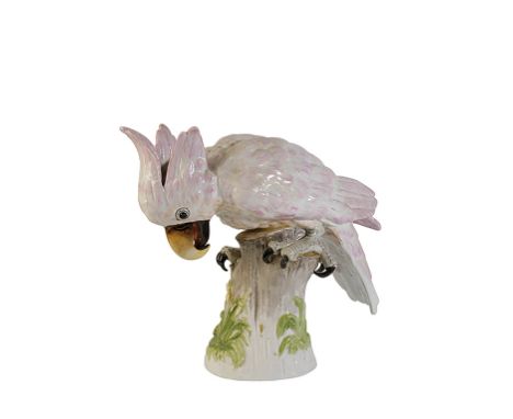 CONTINENTAL PORCELAIN MODEL OF A MACAW modelled with naturalistic plumage on a tree stump, painted in pale enamel colours, 29