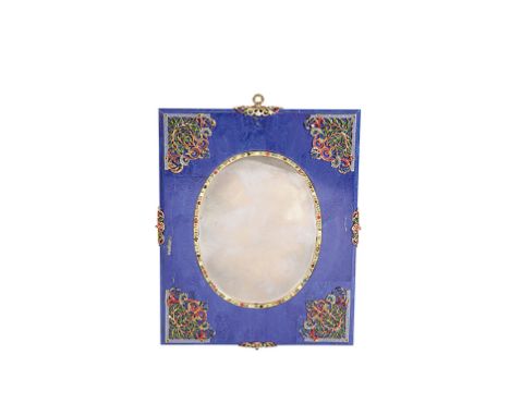 CONTINENTAL LAPIS LUZULI AND ENAMEL MIRROR, the oval plate with a lapis lazuli veneered rectangular frame, applied with assoc