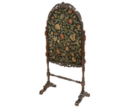 ANGLO-DUTCH WALNUT FIRESCREEN, basically early 18th century, with a floral needlework banner beneath a cresting carved and pi