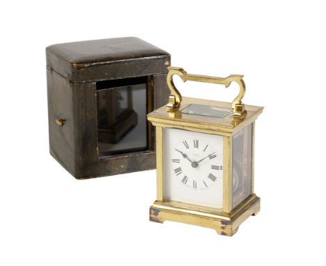 FRENCH GILT BRASS CARRIAGE CLOCK, the white enamel dial inscribed "E DOBBIE NAIROBI", in a gilt brass  case with swing handle