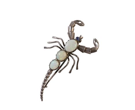 OPAL AND SILVER BROOCH, modelled in the form of a scorpion, set with three graduated opal cabuchons, the eyes set with sapphi