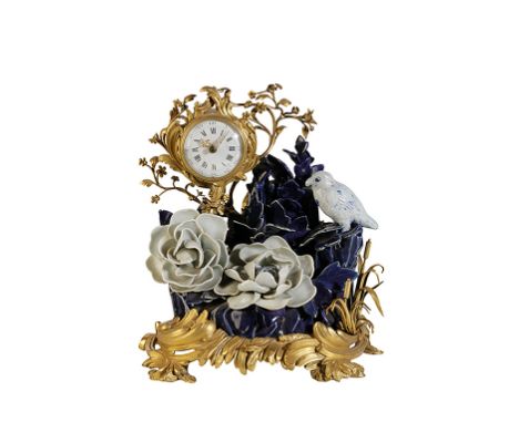 19TH CENTURY ORMOLU MOUNTED MANTLE CLOCK, the convex dial with Roman numerals and outer Arabic numerals in a Rocco style drum
