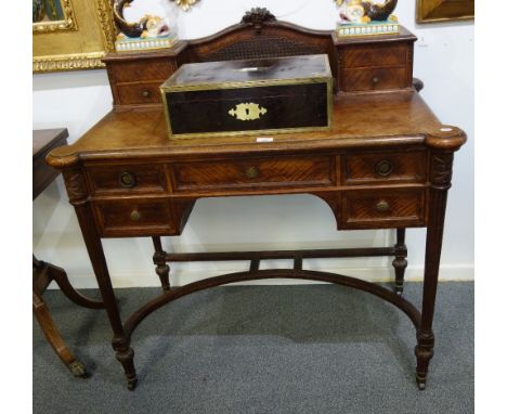 CONTINENTAL WALNUT DRESSING TABLE with a raised superstructure incorporating a bergere panel, over an arrangement of five dra