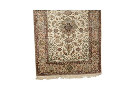 PERSIAN RUG OF ISPHAHAN TYPE, the central rectangular ivory panel worked with a central floral medallion within flowery leafy