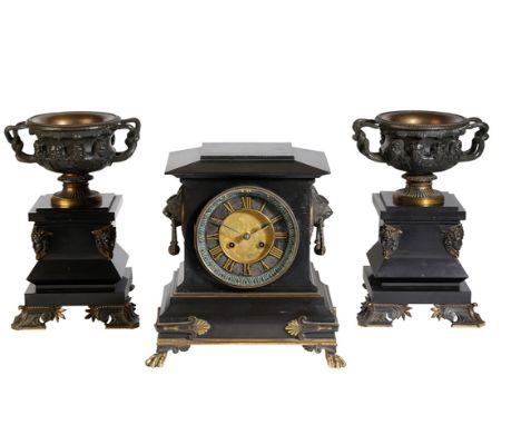 FRENCH BLACK SLATE MANTLE CLOCK WITH URN GARNITURE, the gilt dial with Roman numerals, eight day movement striking on a bell,