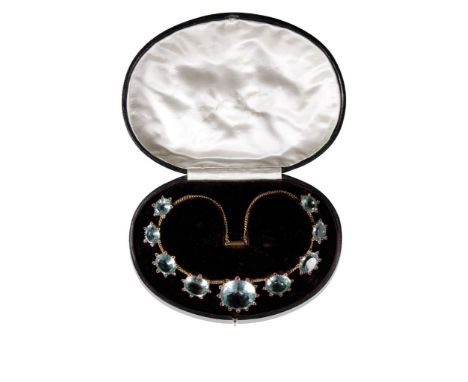 A VICTORIAN AQUAMARINE AND RUBY NECKLACE set in yellow gold with nine aquamarines graduating from the centre, surrounded by l