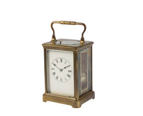 FRENCH BRASS CASED REPEATING CARRIAGE CLOCK, the white enamel dial with Roman numerals, the movement striking on a coiled gon
