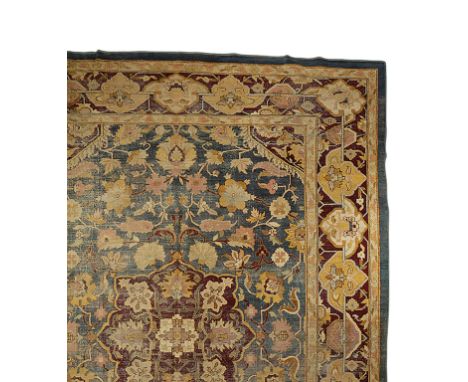 SMALL AGRA CARPET, the blue ground with a central magenta and ivory floral medallion within Hirati style flowerhead and Parme