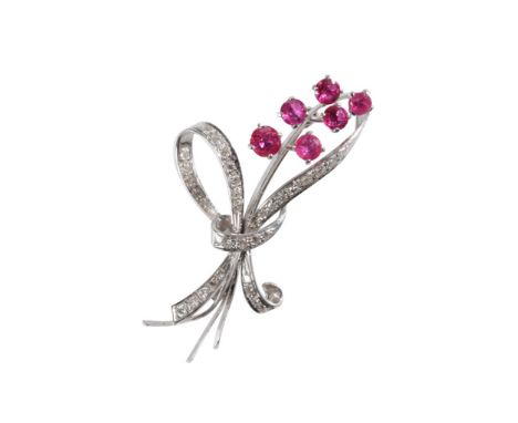DIAMOND AND "RUBY" FLORAL SPRAY BROOCH, six "ruby" flower heads, claw set, joined with diamond set ties, on unmarked white me