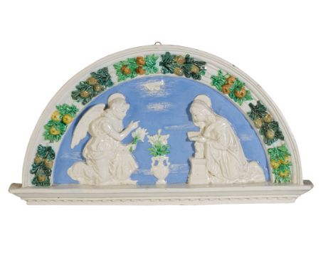 MAJOLICA WALL PLAQUE IN THE MANNER OF DELLA ROBBIA OF ARCHED FORM, modelled in relief with winged angel and kneeling supplica