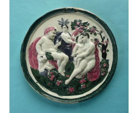 A good Scottish pottery circular plaque moulded with integral border and a scene depicting Bacchus, Venus, Ceres and Cupid, p