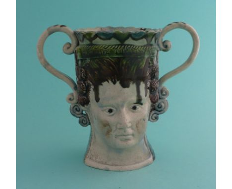 George III and Queen Charlotte: a Prattware dry loving cup modelled as maskheads impressed with loyal statement around the ri