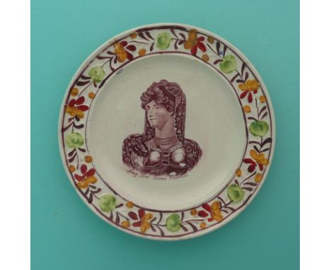 1820 Queen Caroline: a good nursery plate with colourful moulded border printed in brown with a named portrait, 160mm. (comme