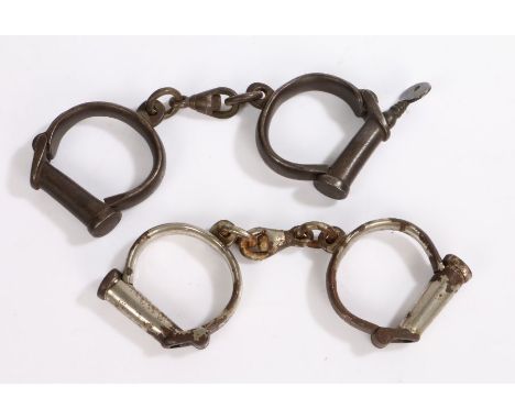 Victorian/Edwardian British police handcuffs, first pair of heavy steel construction, marked 'Hiatt &amp; Co, M &amp; C,' wit